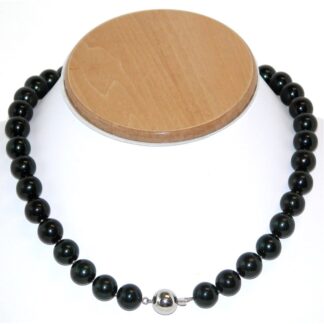 A necklace with black pearls and a silver bead.