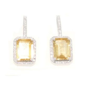 A pair of yellow sapphire and diamond earrings.