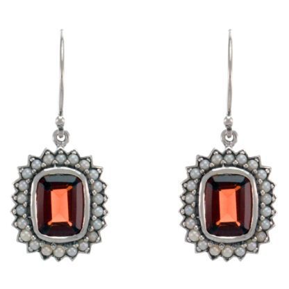 A pair of earrings with garnet stones and diamonds.