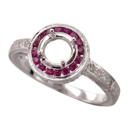 A white gold ring with a round ruby center stone.