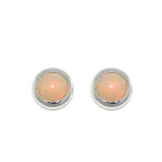 A pair of opal stud earrings on a white background.