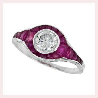 A vintage diamond ring with a ruby halo in 14KT white gold.
