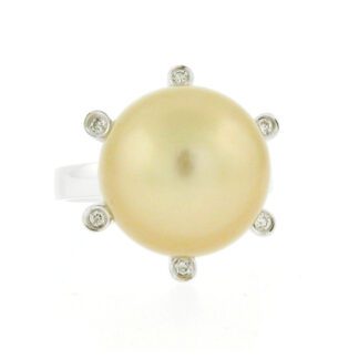 A yellow pearl and diamond ring.